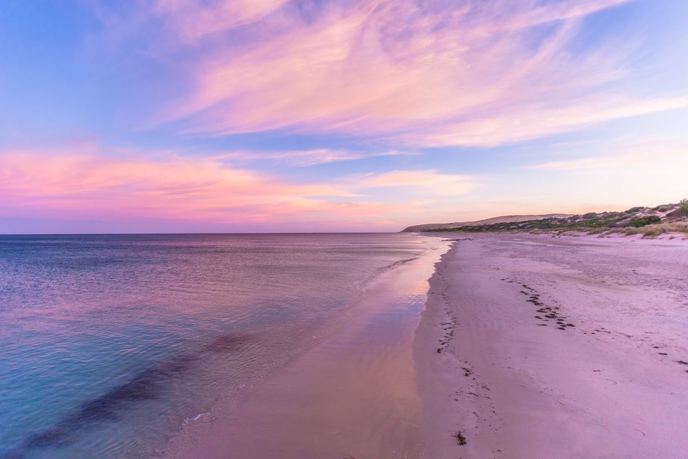 purple sunset over the water and sand at normanville beach