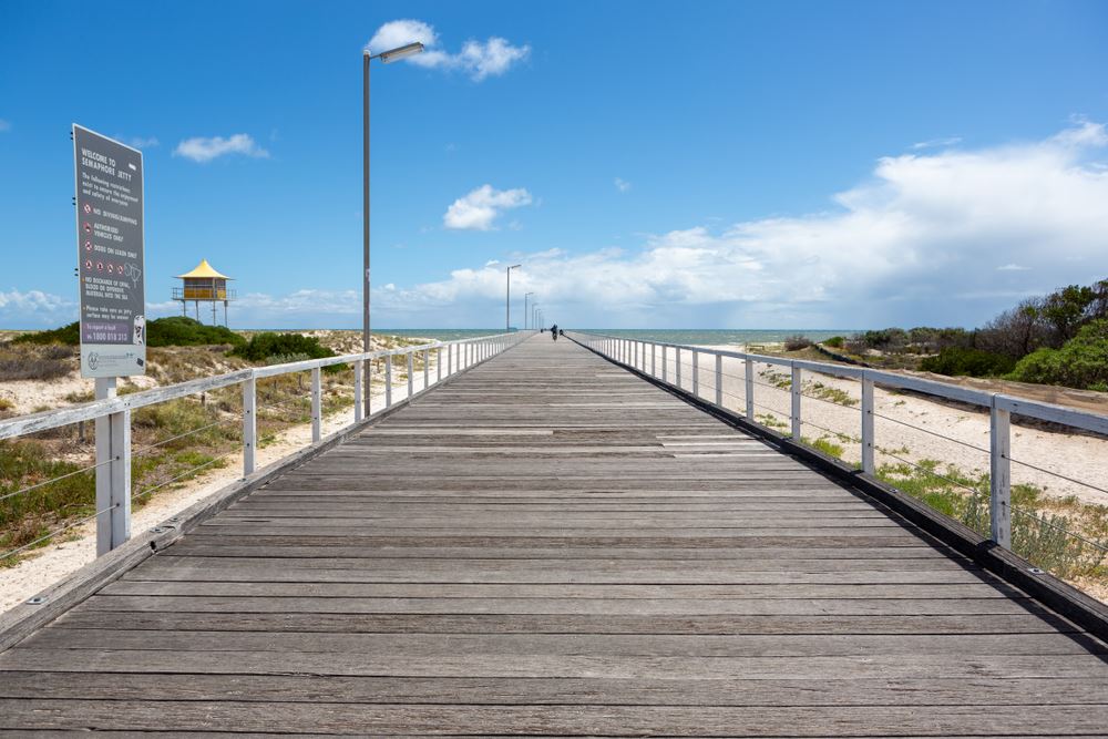 wooden boardwalk leading to water at semaphore